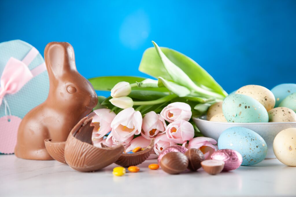 Chocolate easter bunny and candy and flowers