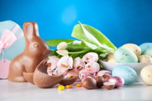 Chocolate easter bunny and candy and flowers