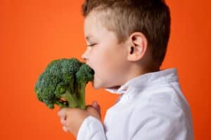 child trying broccoli
