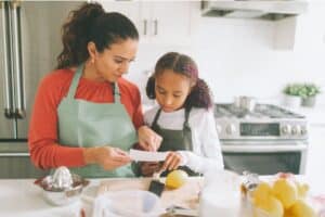 Child with food allergies cooking with mom