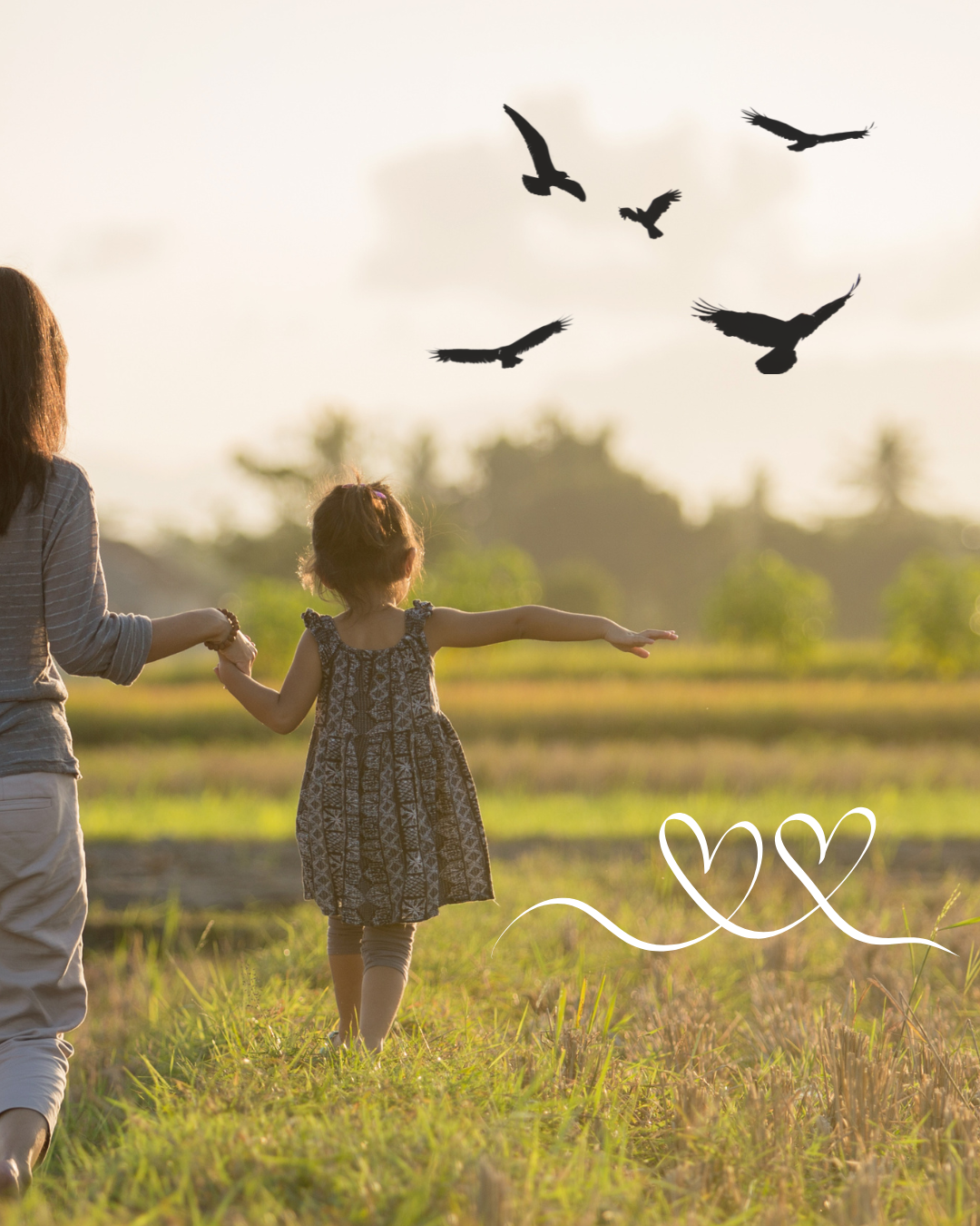 mother and daughter walking in a field