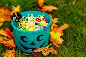 Teal pumpkin bucket filled with toys