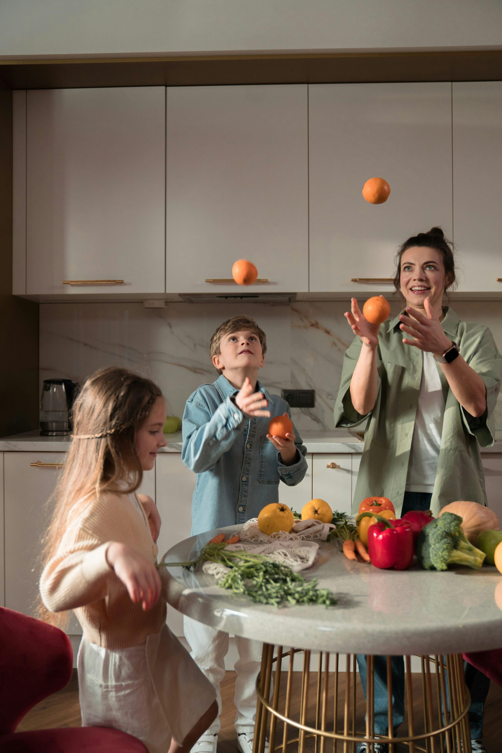 A Mother and Her Children Playing with the Fruits