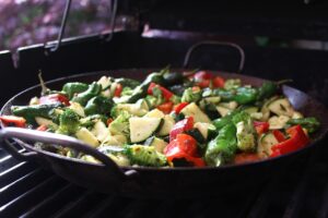 health cooking, sauteing vegetables in a pan for an allergy-friendly meal