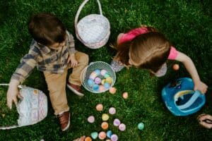 Easter egg hunt with children, easter baskets and toys