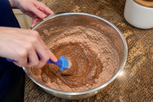 allergy-friendly chocolate muffin batter being mixed in a bowl