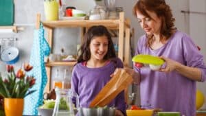 Parent preparing allergy-friendly school lunch for child