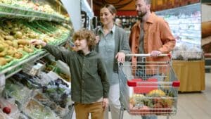 Child with food allergies choosing new fruits and vegetables